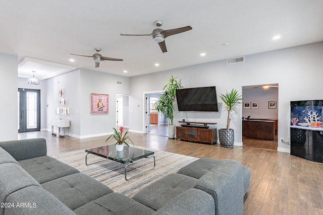 living room with light wood-type flooring and a chandelier