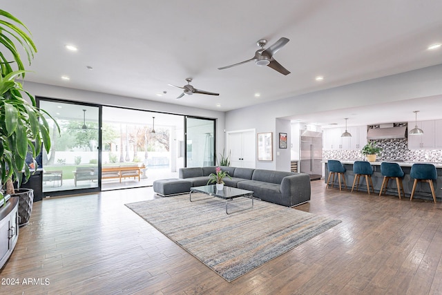 living room with ceiling fan and hardwood / wood-style flooring