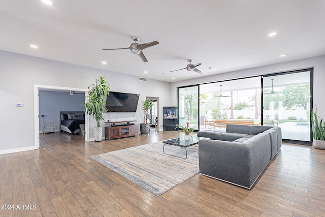 living room with ceiling fan and hardwood / wood-style flooring