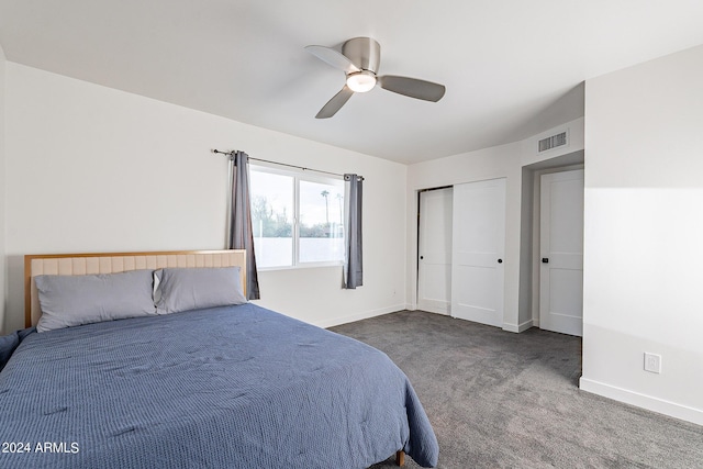 unfurnished bedroom featuring ceiling fan and dark colored carpet