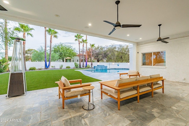 view of patio with ceiling fan and a fenced in pool