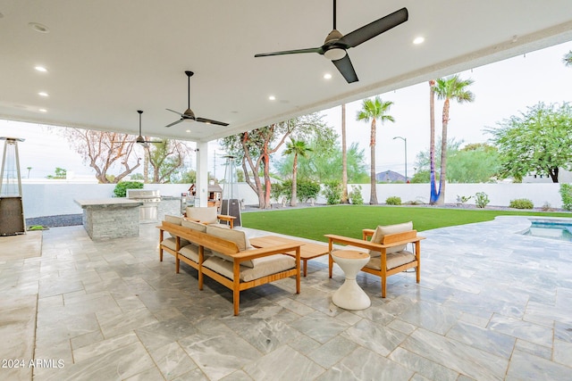 view of patio / terrace featuring ceiling fan and exterior kitchen