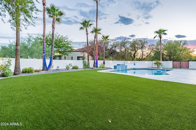 view of yard featuring a fenced in pool and a patio