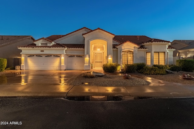 mediterranean / spanish-style home featuring a garage