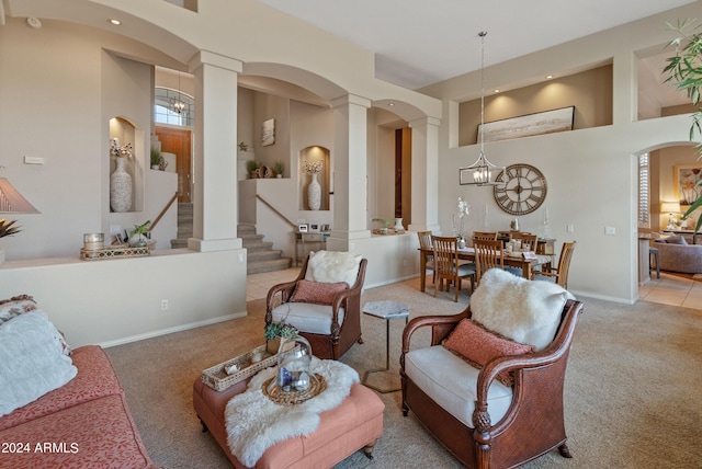 living room featuring carpet flooring and ornate columns