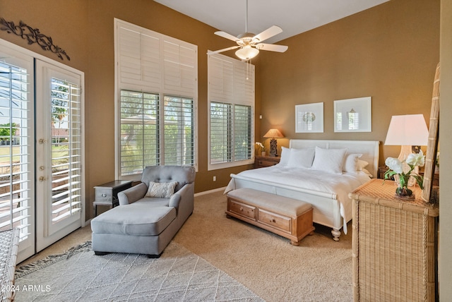 carpeted bedroom featuring ceiling fan, a towering ceiling, and access to outside