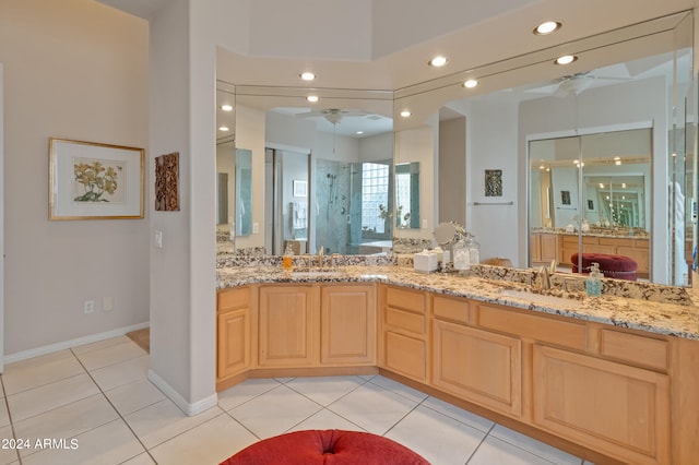 bathroom with tile patterned flooring, vanity, ceiling fan, and an enclosed shower