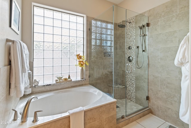 bathroom with separate shower and tub and tile patterned floors