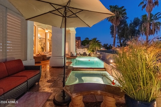 patio at twilight featuring an outdoor hangout area and a pool with hot tub