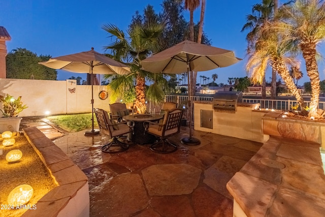 patio at twilight with area for grilling and grilling area