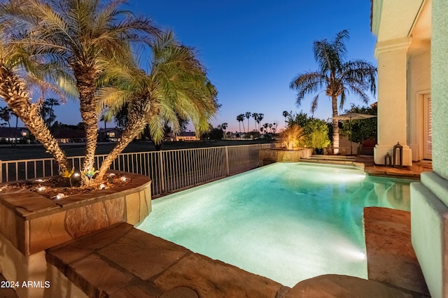 view of pool at dusk