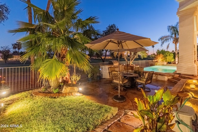 yard at dusk featuring a patio