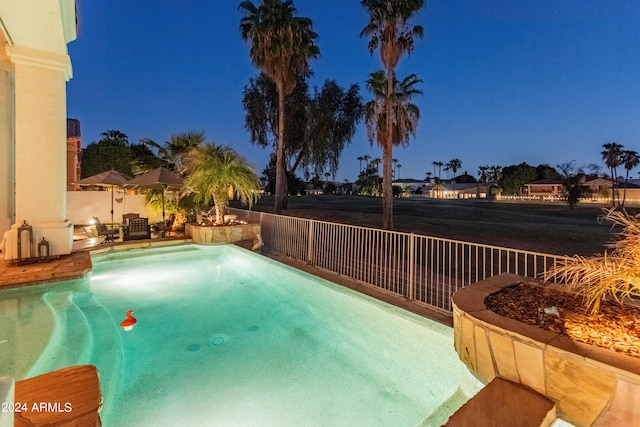 pool at twilight with a patio