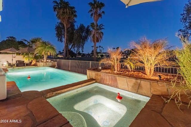 view of pool featuring a patio and an in ground hot tub