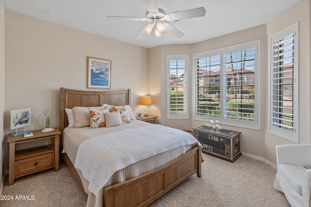 bedroom featuring light colored carpet and ceiling fan