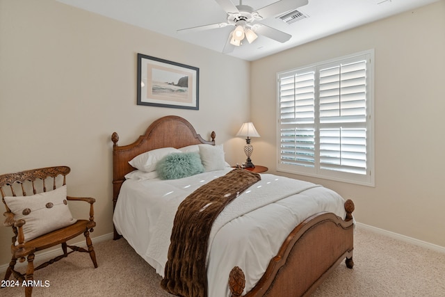 carpeted bedroom with multiple windows and ceiling fan