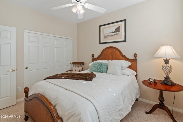 carpeted bedroom featuring ceiling fan and a closet