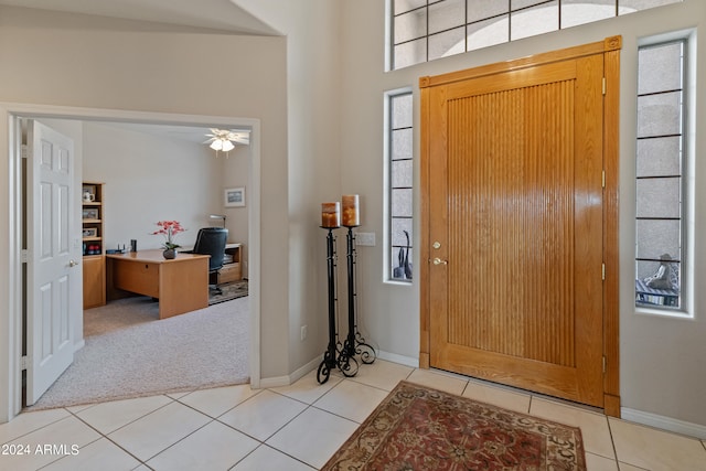 tiled entryway with ceiling fan