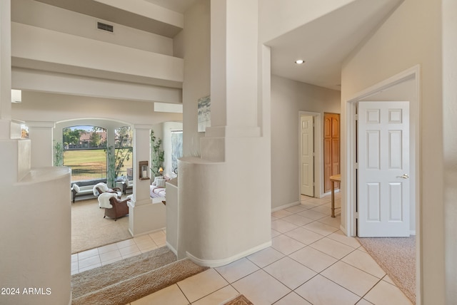 corridor featuring light tile patterned floors