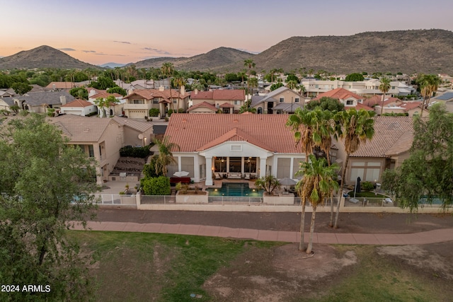 aerial view at dusk featuring a mountain view