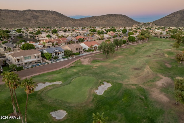 aerial view at dusk featuring a mountain view