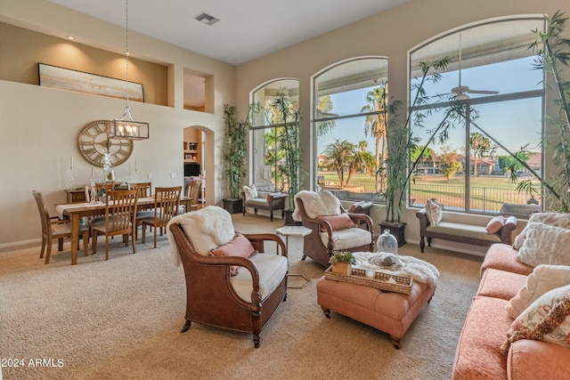 carpeted living room featuring ceiling fan