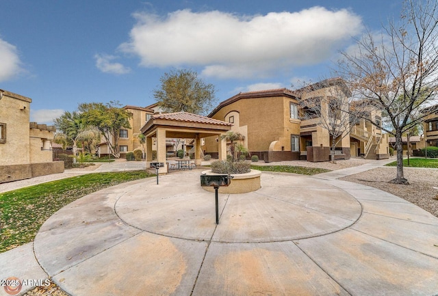 view of home's community featuring a gazebo, a residential view, and stairs