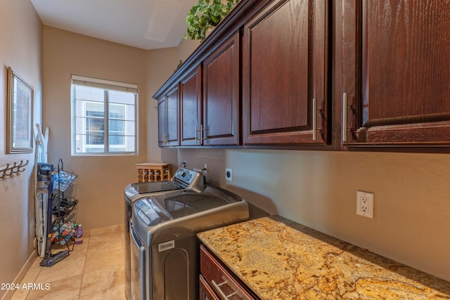 laundry area with cabinets, independent washer and dryer, and light tile patterned floors