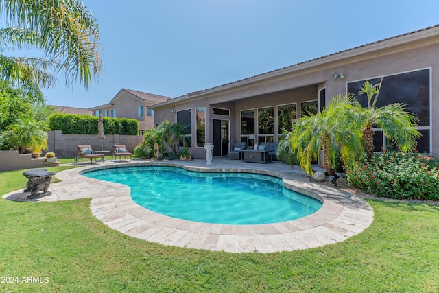 view of pool featuring a yard and a patio