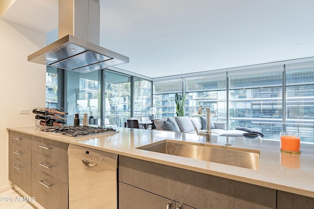 kitchen featuring a sink, dishwasher, island range hood, and stainless steel gas cooktop