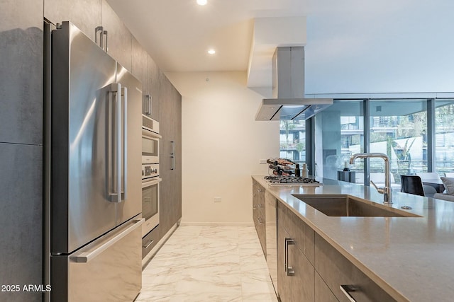 kitchen with island exhaust hood, a sink, appliances with stainless steel finishes, modern cabinets, and marble finish floor