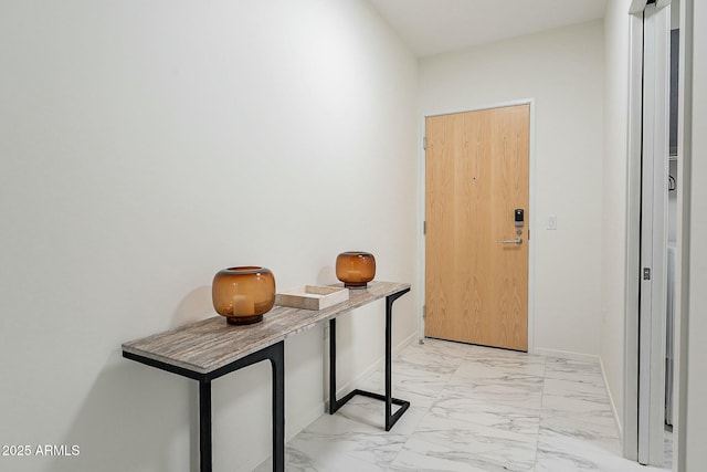 interior space featuring baseboards and marble finish floor