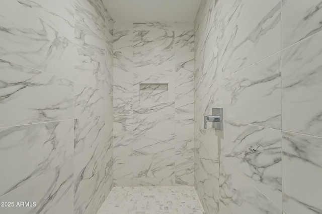 bathroom with a tile shower
