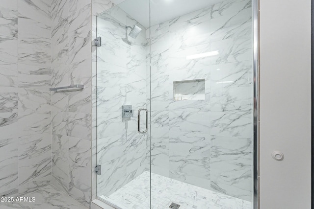 bathroom with a marble finish shower