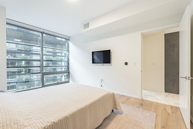 bedroom with visible vents and light wood finished floors