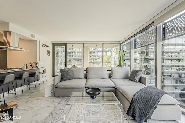 living room with visible vents and marble finish floor