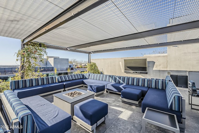 view of patio with an outdoor living space with a fire pit