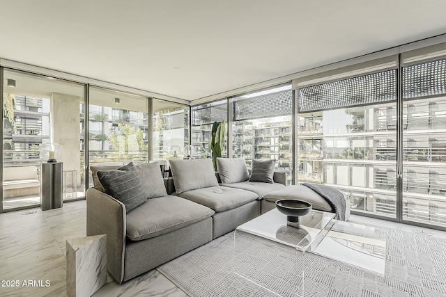 living area with marble finish floor and expansive windows