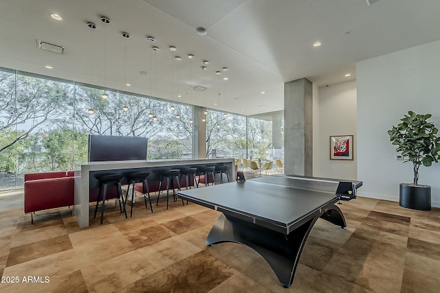 game room featuring recessed lighting and expansive windows