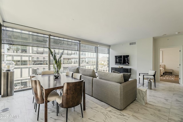 interior space with visible vents, marble finish floor, and expansive windows