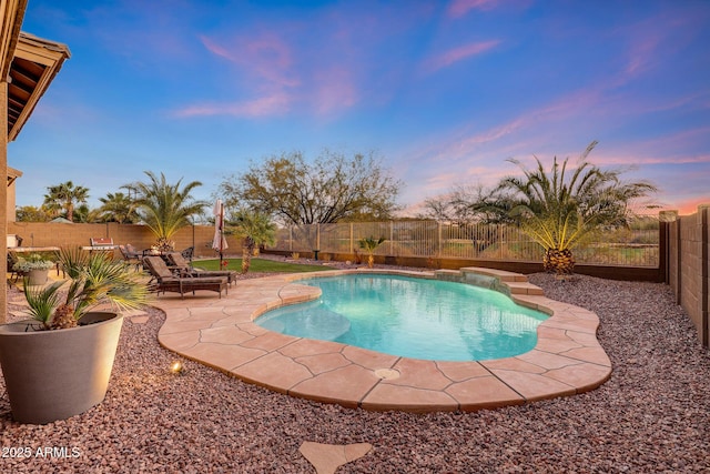 pool at dusk featuring a patio area