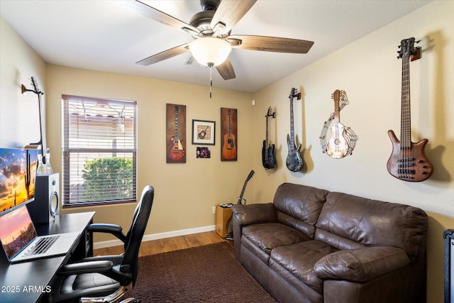 home office with wood finished floors, a ceiling fan, and baseboards