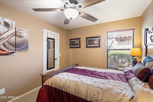 carpeted bedroom featuring baseboards and ceiling fan