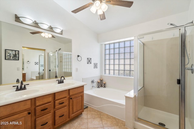 bathroom with a shower stall, double vanity, tile patterned floors, and a sink