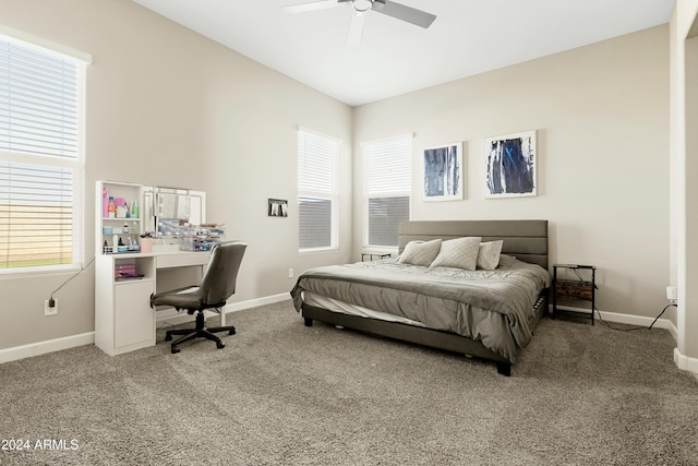 carpeted bedroom featuring ceiling fan and multiple windows