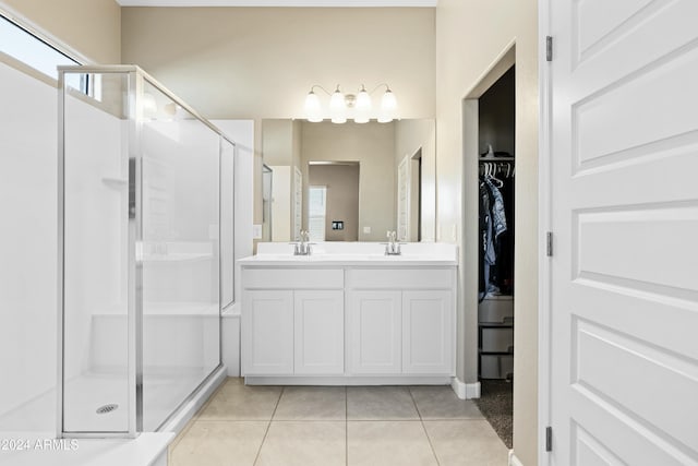 bathroom with tile patterned flooring, vanity, and an enclosed shower