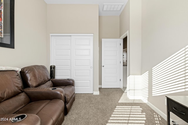 carpeted living room featuring a high ceiling