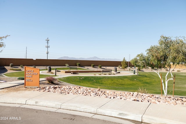 surrounding community featuring a lawn and a mountain view