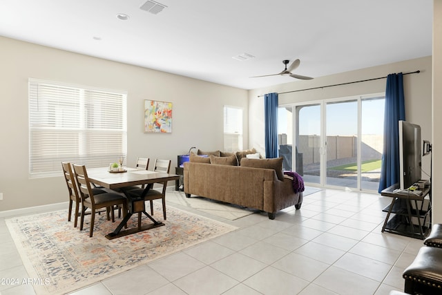 dining space featuring ceiling fan and light tile patterned floors