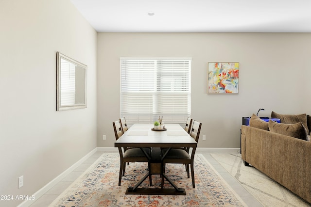 dining room with light tile patterned floors and a wealth of natural light